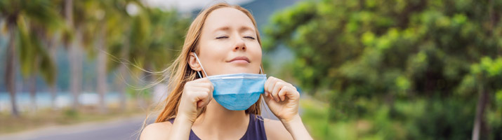 Girl removing face mask